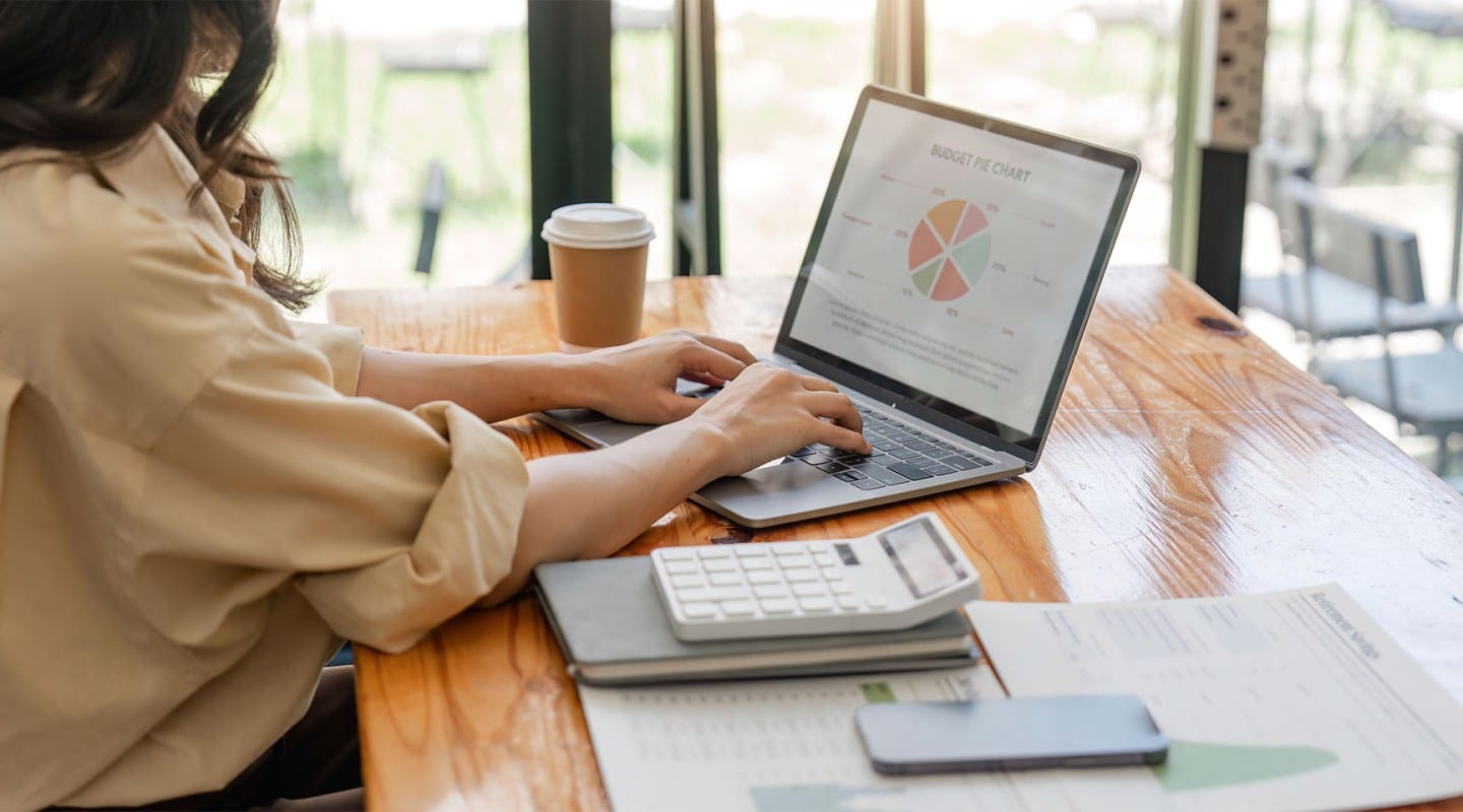 young lady working on investment portfolio at home